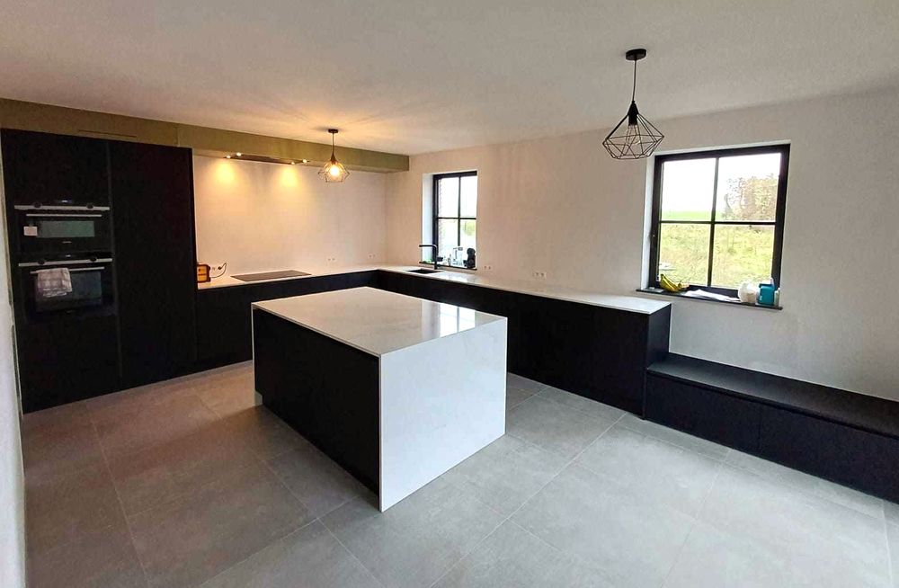 Zwarte keuken met wit eiland in open ruimte